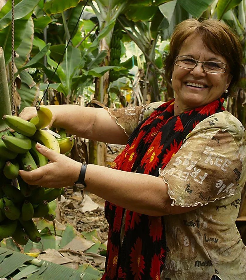 woman with a pineapple of bananas